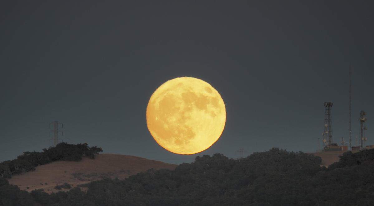 A full moon rises over the hills in Arroyo Grande in a view Sunday night from Cindy Way.