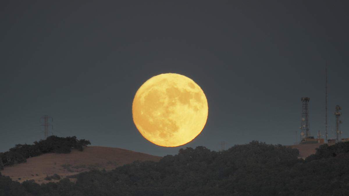 A full moon rises over the hills in Arroyo Grande in a view Sunday night from Cindy Way.