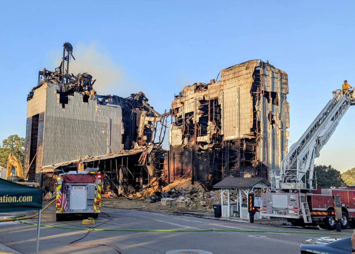 Firefighters continue to work on the burned-out ruins of the Templeton Feed & Grain building on July 5, 2025, after the historic structure caught fire late on the night of the Fourth of July.