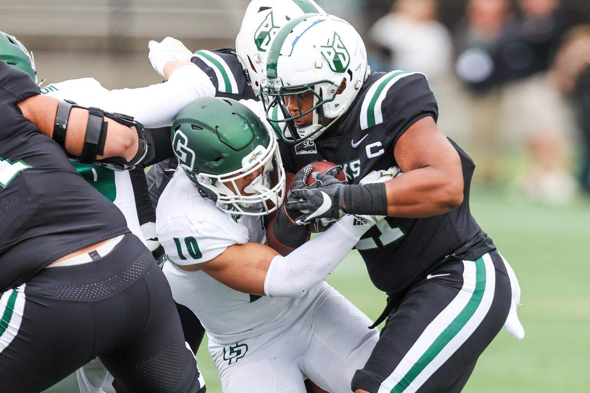 Cal Poly linebacker David Meyer (10) tackles Portland State running back Andrew Van Buren (21) in the Mustangs’ 59-21 loss to the Vikings in a Big Sky football game on Sept. 23, 2023, at Hillsboro Stadium.