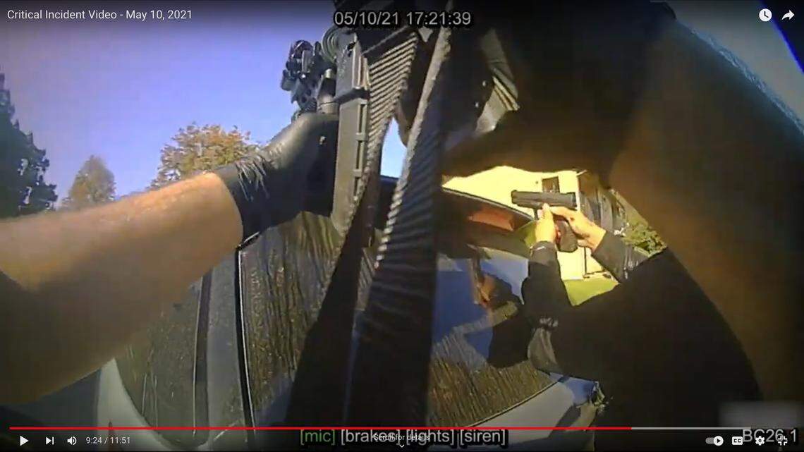 In a screenshot from body camera video, a police officer checks on Det. Steve Orozco, who was injured after being shot by Edward Giron while serving a search warrant at Giron’s Camellia Court apartment in San Luis Obispo on May 10, 2021. Giron shot and killed Det. Luca Benedetti in the incident.