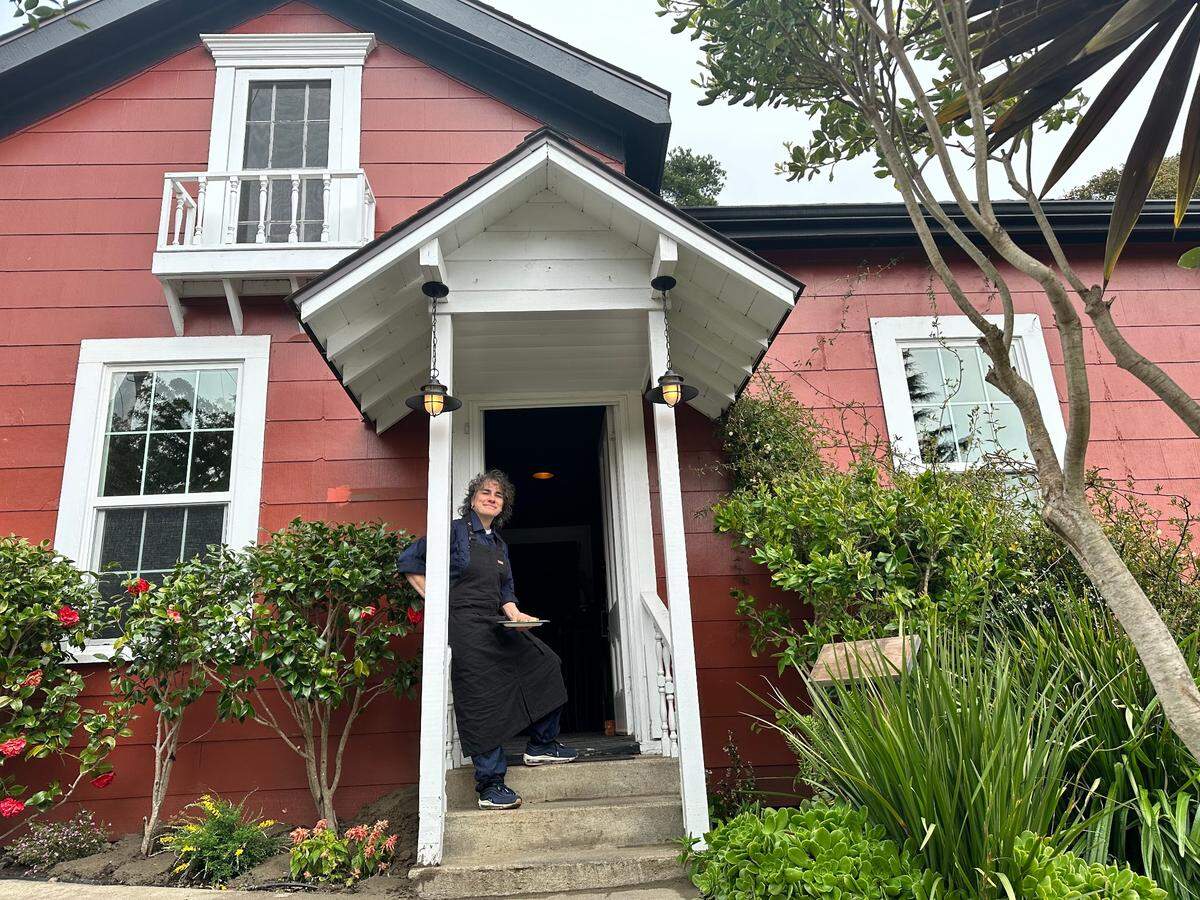 Elaine Rivera-Glenn, chef and partner of Brydge in Cambria, stands in the entry of the Victorian-era house that houses the restaurant.