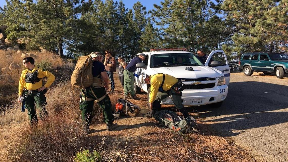 Santa Barbara County Search and Rescue team members gather on East Camino Cielo on Thursday during the search for a downed paraglider near La Cumbre Peak in the mountains above Santa Barbara.