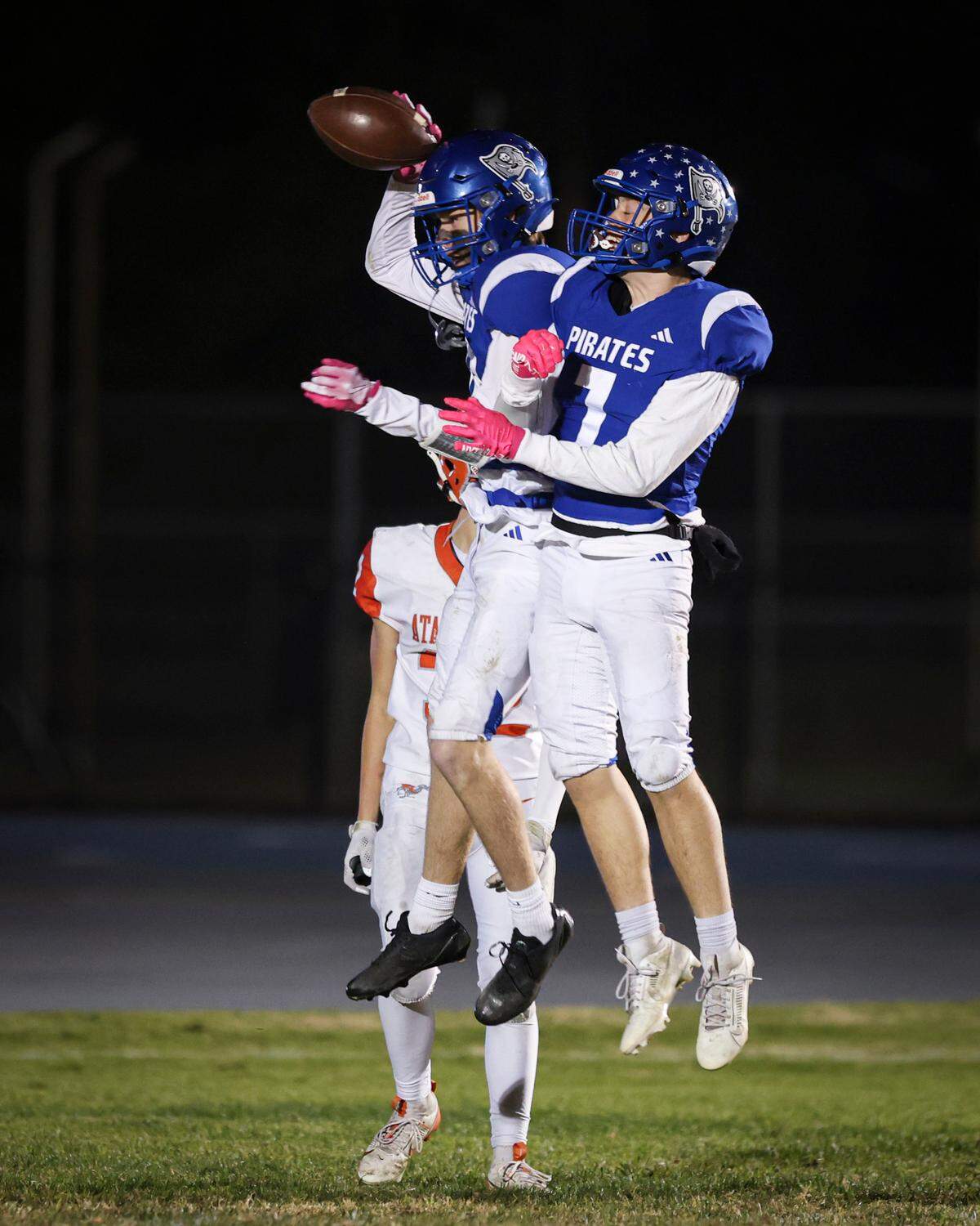 Ryder Busch, holding football, celebratesa touchdown catch and run to endzone with James Nickel. Morro Bay beat Atascadero 42-14 on Nov. 15, 2024.
