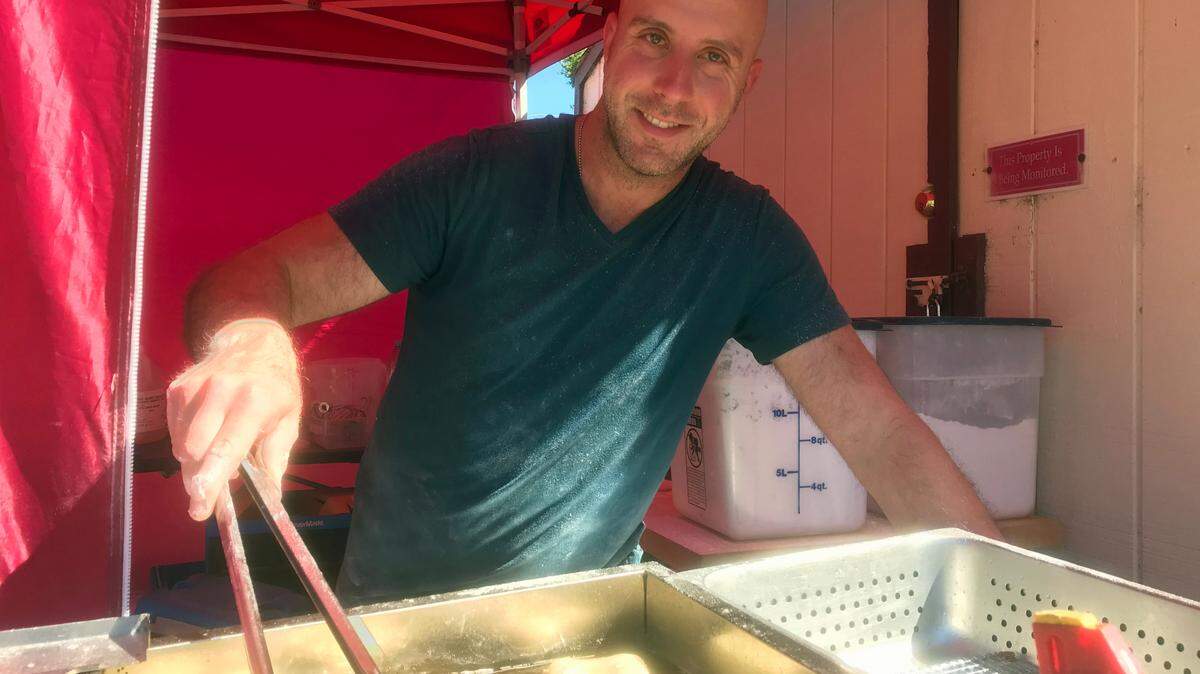 David Perlis, owner of The Second Line, fries up some of his beignet pastries at the Cambria Farmers Market on June 10. 2022. Perlis discovered June 19 that the trailer and equipment he uses for the business had been stolen.