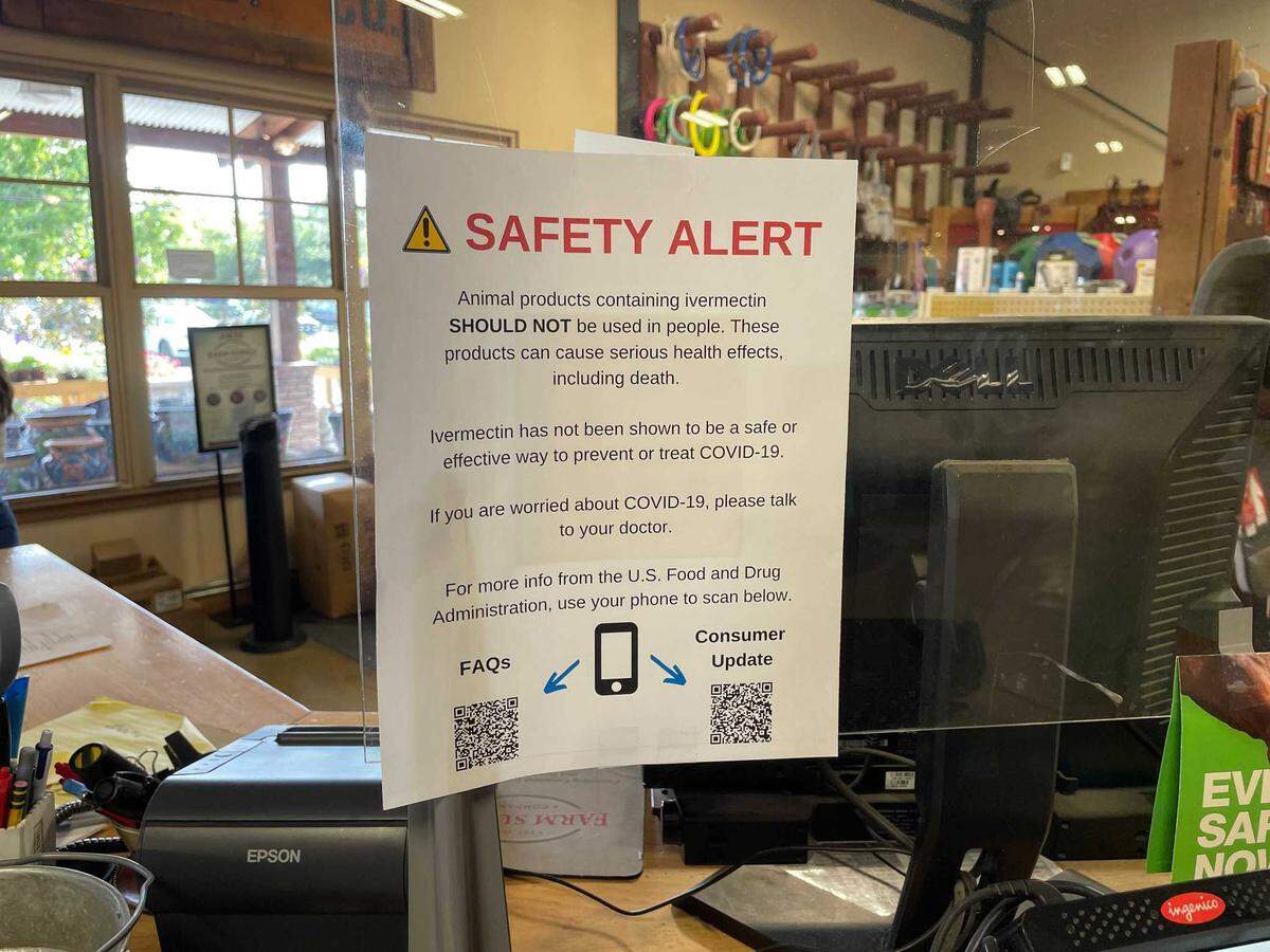 A sign warning against human use of ivermectin products intended for animals hangs on a plastic protective barrier near a cash register at the Farm Supply in San Luis Obispo. A human version of the drug is used to kill parasites, but some people have been using it as a treatment for COVID-19. The FDA has said ivermectin should not be used for this purpose, and a prescription is required. To get around restrictions on the human version, some people have been purchasing ivermectin formulated for horses and livestock.