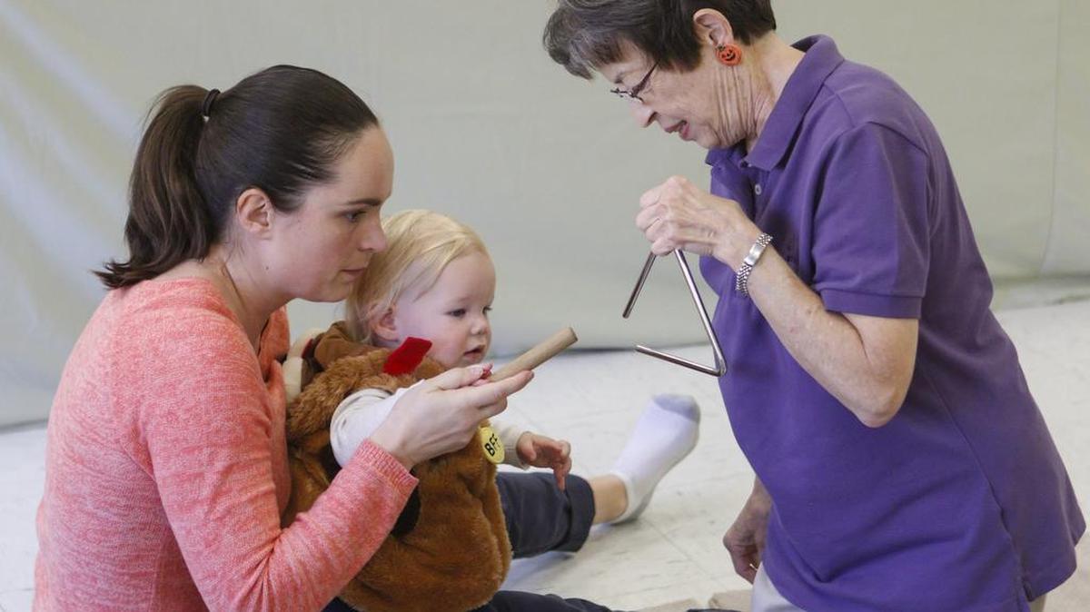 Doreen McNeill and son Logan with teacher Nancy Knox play the triangle. Kids were in costume for Halloween. Babies and toddlers play instruments, sing and dance together at Paso’s Centennial Park Recreation Center.
