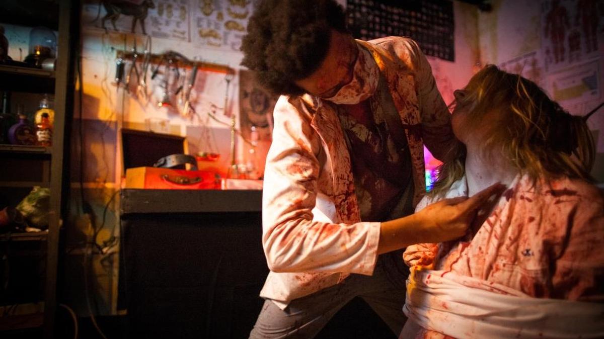 A volunteer actor scares up screams “operating on” another actor at The Haunt in Atascadero.