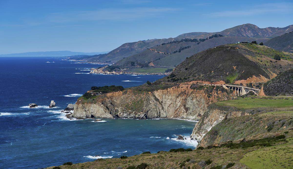 Highway 1 winds along the Big Sur Coast and the Bixby Bridge.