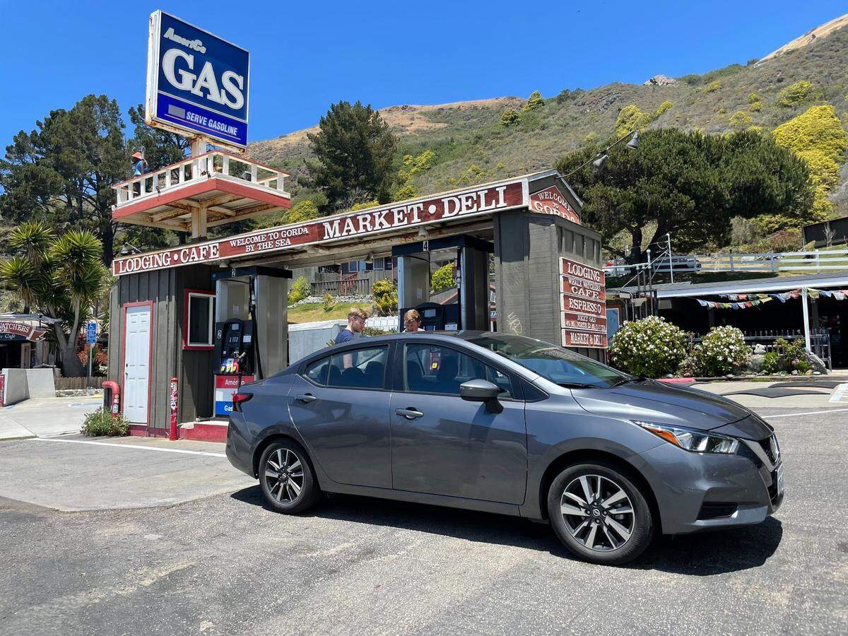 Drivers react with laughs, photos and shrugs to the gas prices at the AmeriCo station in Gorda, California, on June 27, 2022. The Highway 1 station along the Big Sur coast is one of the most expensive in the United States.