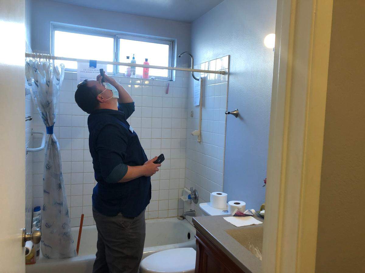 John Mezzapesa, a San Luis Obispo code enforcement officer, inspects a bathroom in a rental home in the city. San Luis Obispo has more code enforcement staff than any city in San Luis Obispo County.