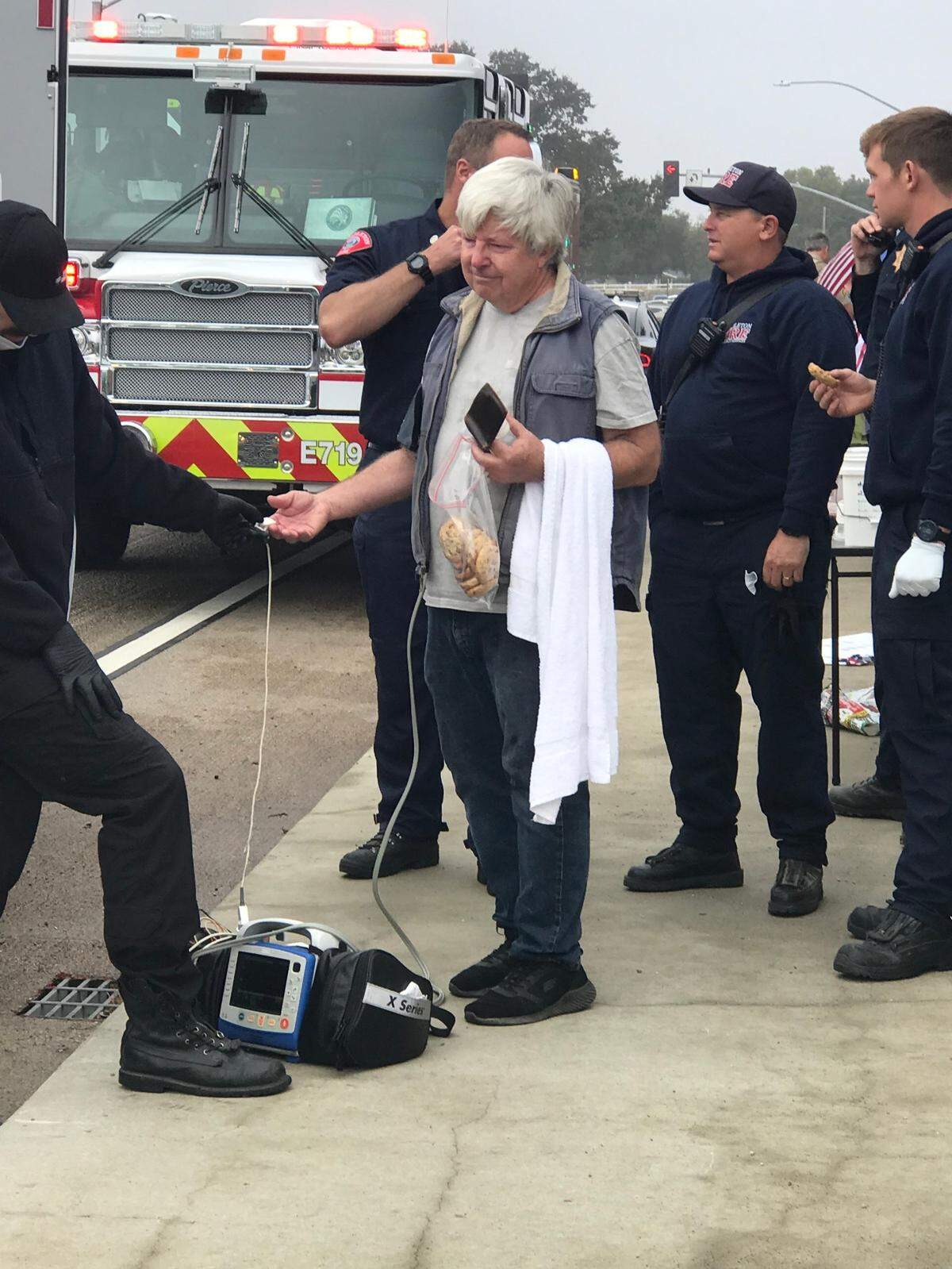 An activist is checked out by emergency personnel after he was pepper-sprayed during a “pro-democracy” demonstration on the Vineyard Drive overpass in Templeton on Sept. 20, 2022.