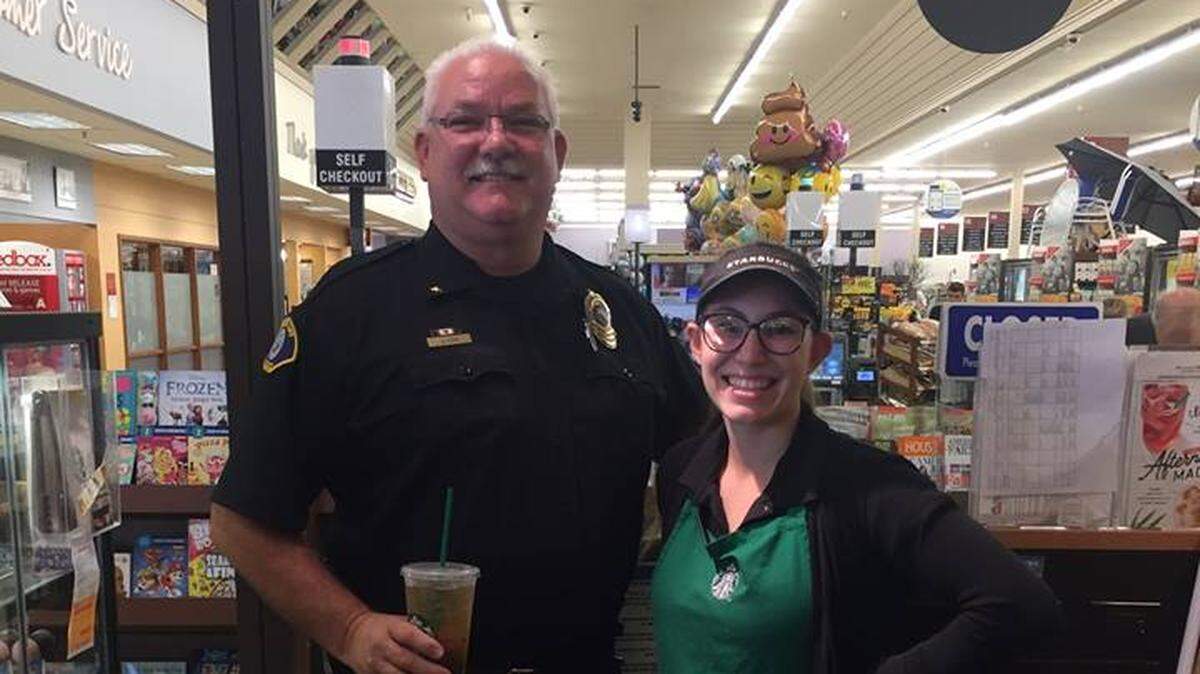 New Morro Bay Police Chief Jody Cox, left, poses for a photo with a Starbucks barista in July.