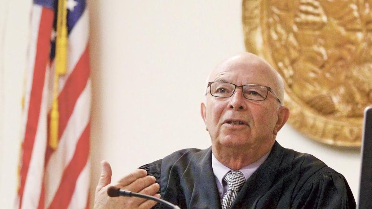 Commissioner Stephen Sefton gives those gathered at Small Claims Court an outline of how the day will proceed during hearings in June at the Veterans Memorial Building in San Luis Obispo.