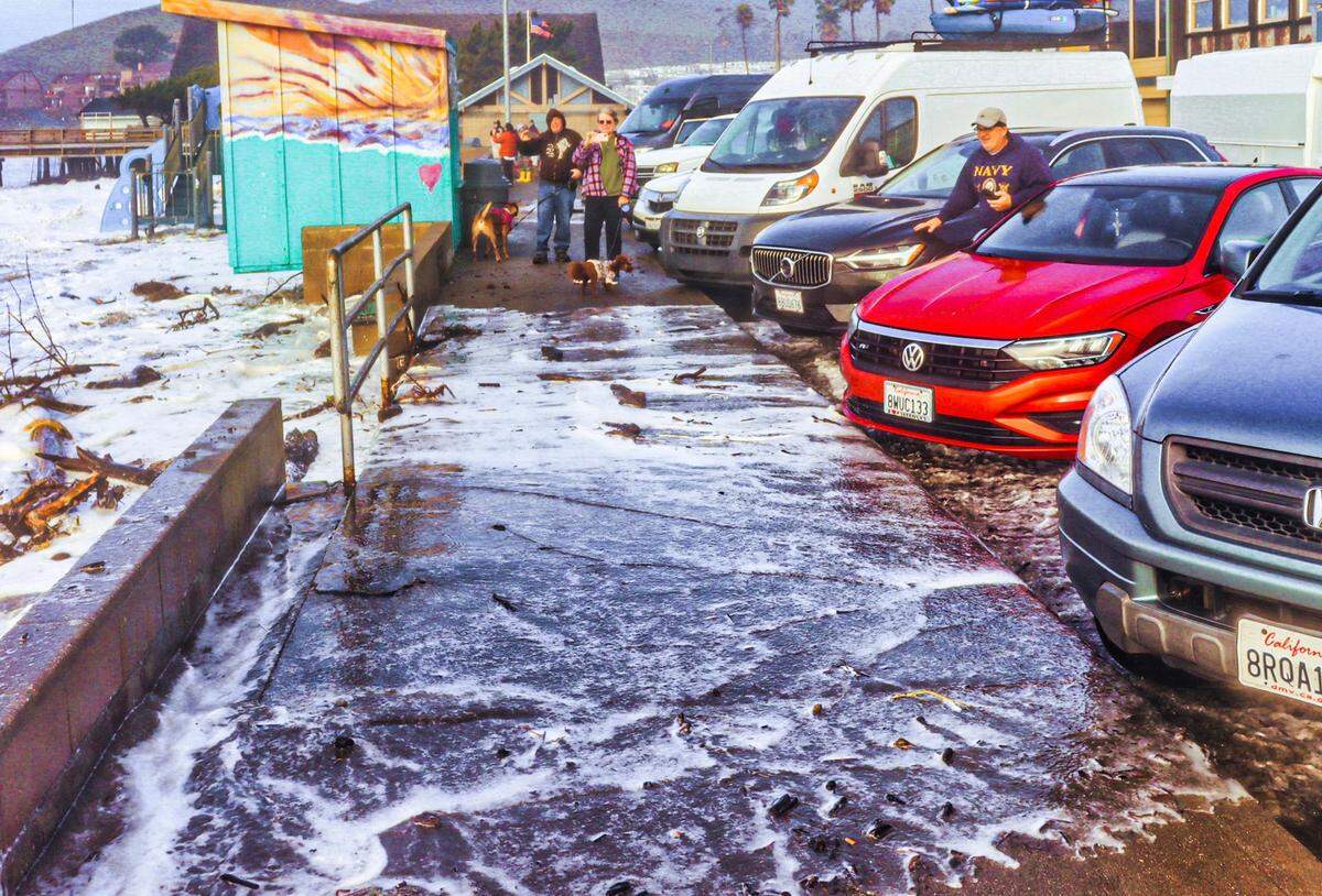 High surf washes over the sidewalk in Cayucos on Jan. 5, 2023, after a powerful winter storm moved through the area.
