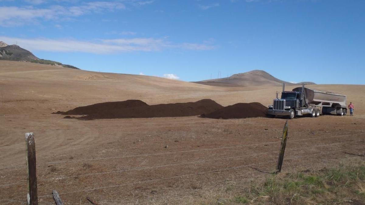 Compost is applied to a field on the Buckingham ranch to improve the soil.