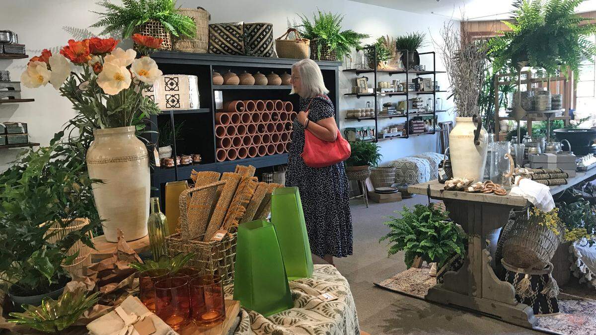 One of the first customers at Terracotta Home and Garden browses moments after owner Jacqueline Norgan first opened the Cambria store on Sept. 2, 2022.