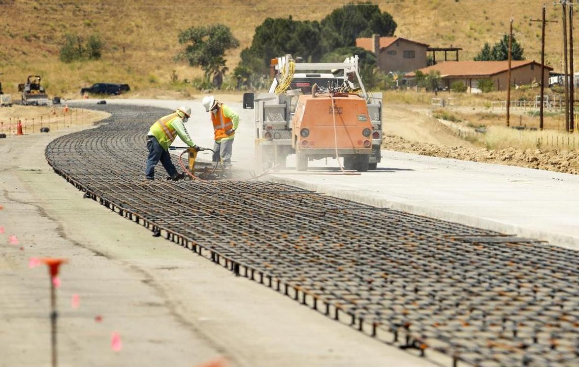 Highway 46 crews work on the steel-reinforced road foundation before concrete is poured near the Shandon rest stop.