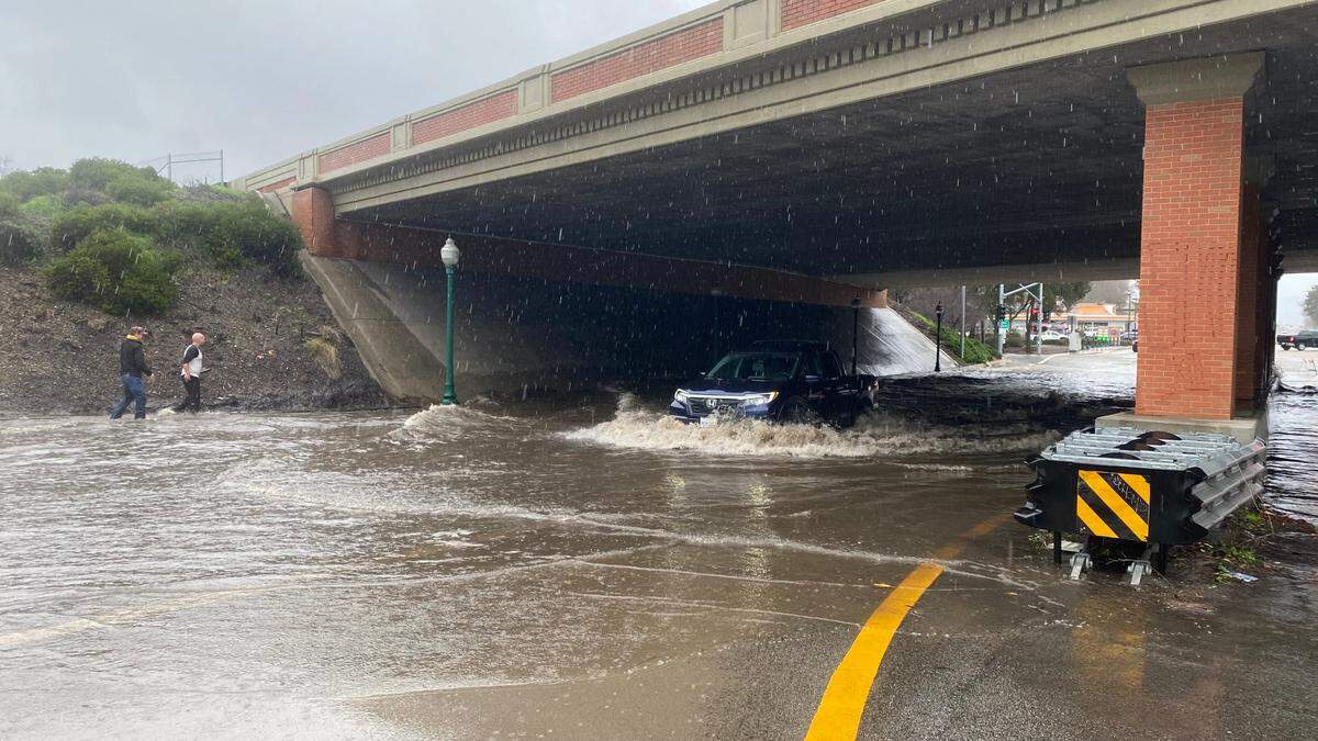 A pickup truck plows through floodwaters at the Highway 41 underpass below Highway 101 in Atascadero on Jan. 9, 2023.