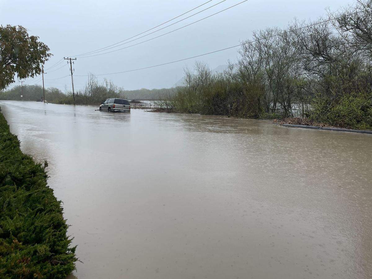 A car submerged in floodwaters on Quintana Road at South Bay Boulevard in Morro Bay on March 10, 2023.