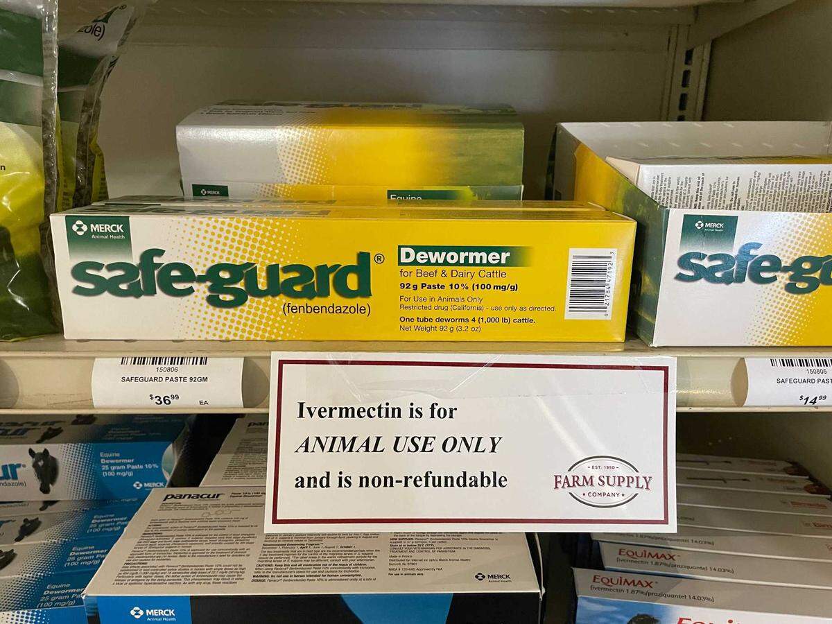 Signs warning against human use of ivermectin products intended for animals hang on shelves containing horse dewormers at Farm Supply in San Luis Obispo. A human version of the drug is used to kill parasites, but some people have been using it as a treatment for COVID-19. The FDA has said ivermectin should not be used for this purpose, and a prescription is required. To get around restrictions on the human version, some people have been purchasing ivermectin formulated for horses and livestock.