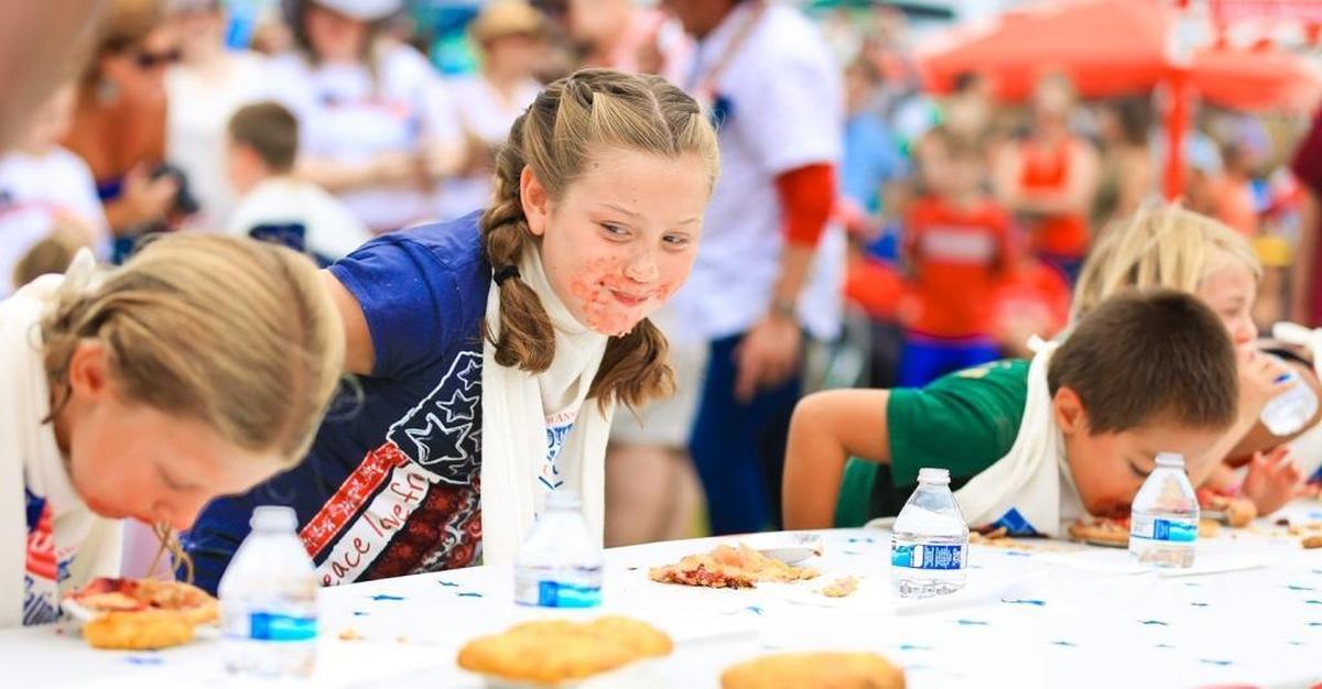 Kids compete in a pie-eating contest during Fourth of July events at Shamel Park in Cambria.