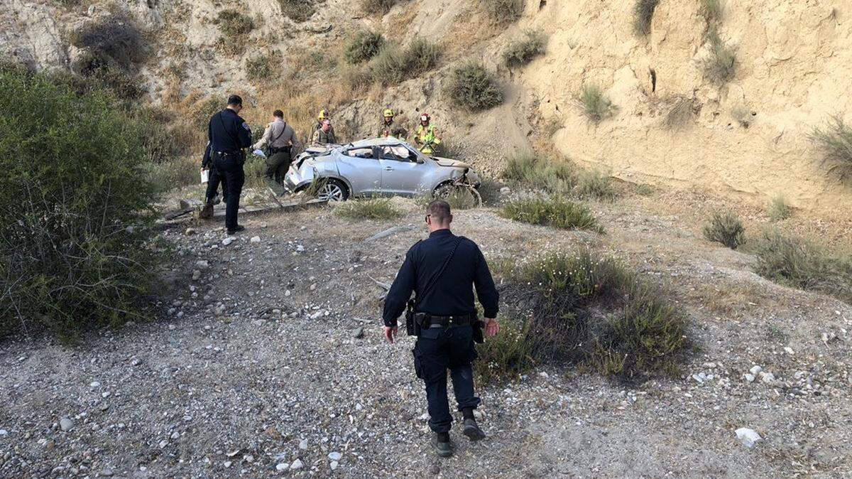 Law enforcement and emergency responders assess the scene of a vehicle crash east of San Miguel. The vehicle veered off the road and down a cliff, killing one person.
