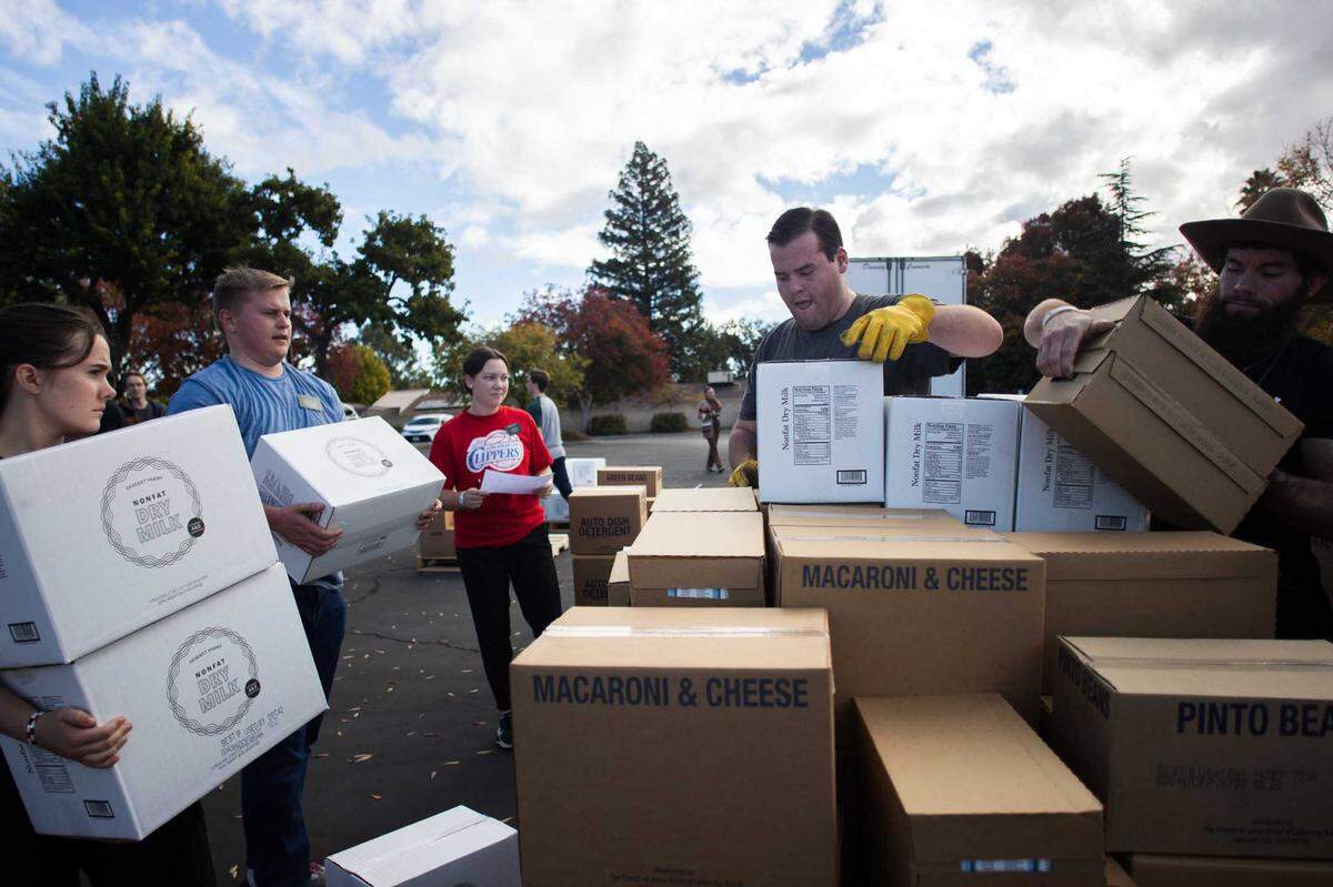 Volunteers sort food donated by The Church of Jesus Christ of Latter-day Saints in Paso Robles on Thursday, Nov. 16, 2023.