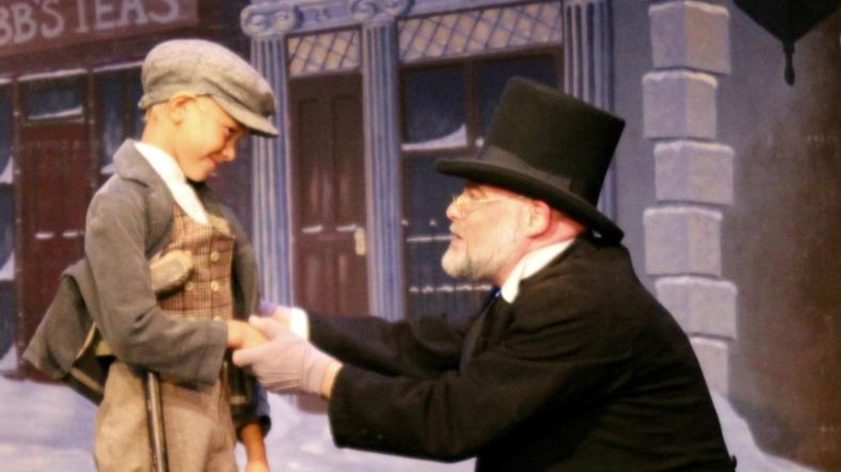 Tiny Tim (Bennet Witlieb) and Ebenezer Scrooge (Beau Hickman) appear in a scene from “A Christmas Carol,” part of “The Holiday Extravaganza.” The show through Dec. 31 at the Great American Melodrama and Vaudeville in Oceano.