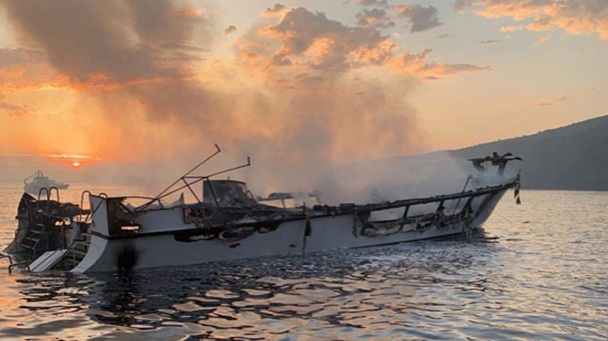 The burned-out hull of the Santa Barbara-based Conception dive boat shortly before it sank Monday near Santa Cruz Island. Four bodies have been recovered, and at least 29 people are missing or feared dead.