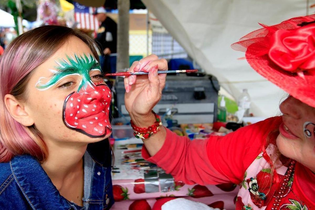 Grover Beach resident Teresa Schmidt paints a large strawberry on Lava Farmer of Nipomo at the Arroyo Grande Strawberry Festival in 2016. The festival returns to the Village of Arroyo Grande this Memorial Day weekend.