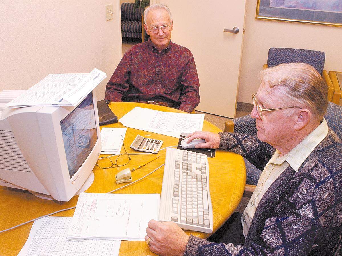 Robert Patton, a volunteer tax preparer with AARP, assists John Boruk with his tax return in 2010 in Pismo Beach. Seniors and those who quality based on lower or moderate income can get free tax help by calling for an appointment.