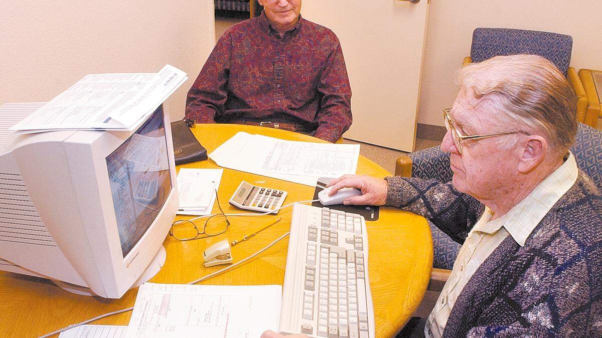 Robert Patton, a volunteer tax preparer with AARP, assists John Boruk with his tax return in 2010. Seniors and those who quality based on lower or moderate income can get free tax help by calling for an appointment.