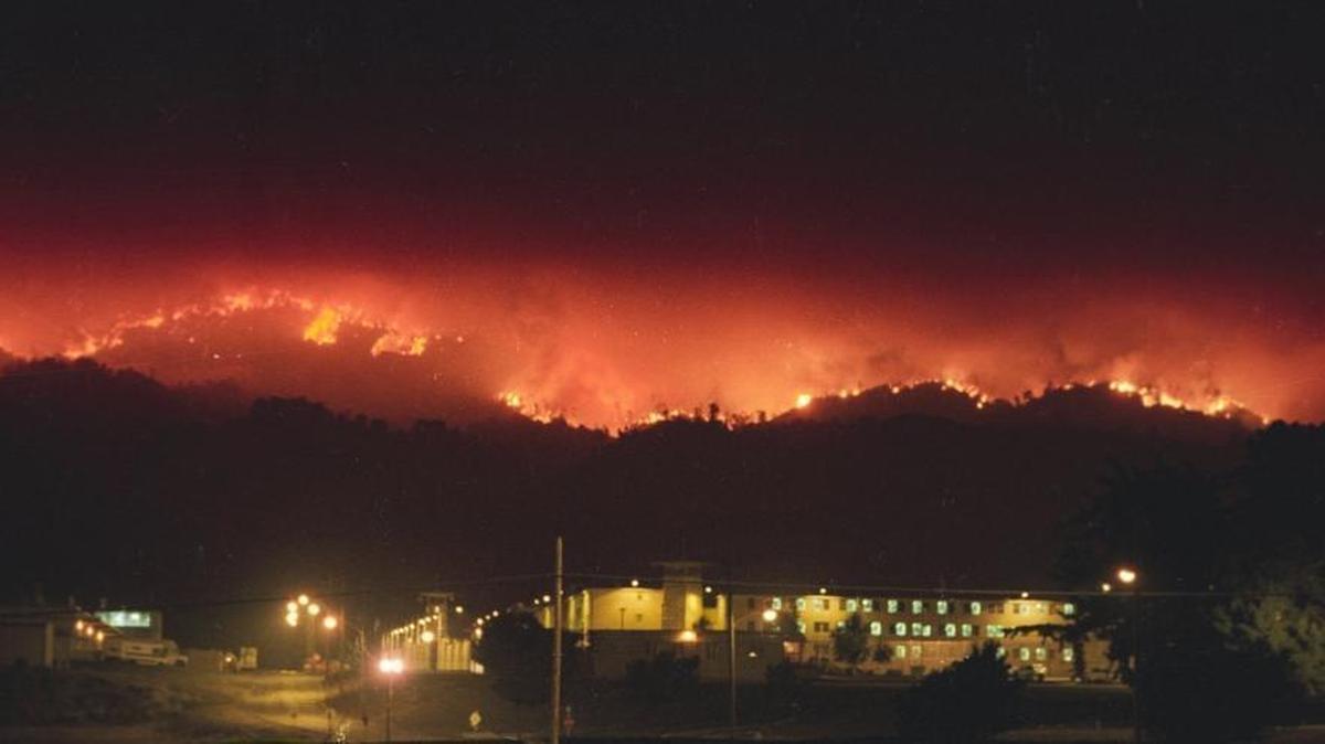 Flames from the Highway 41 Fire burn along the Santa Lucia Range behind the California Men’s Colony the night of Aug. 15, 1994. The fire crossed Cuesta Grade and threatened CMC.