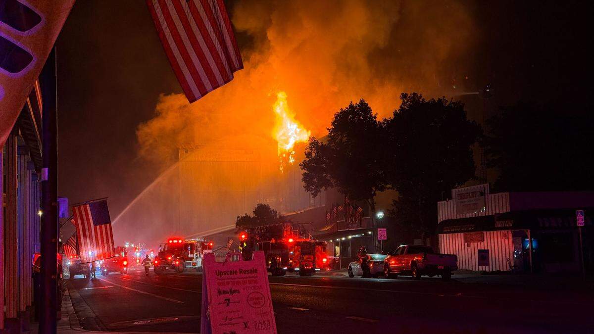 Flames could be seen erupting from an upper floor and roof area of Templeton Feed & Grain early July 5, 2025, as firefighters attempted to save the building.&nbsp;