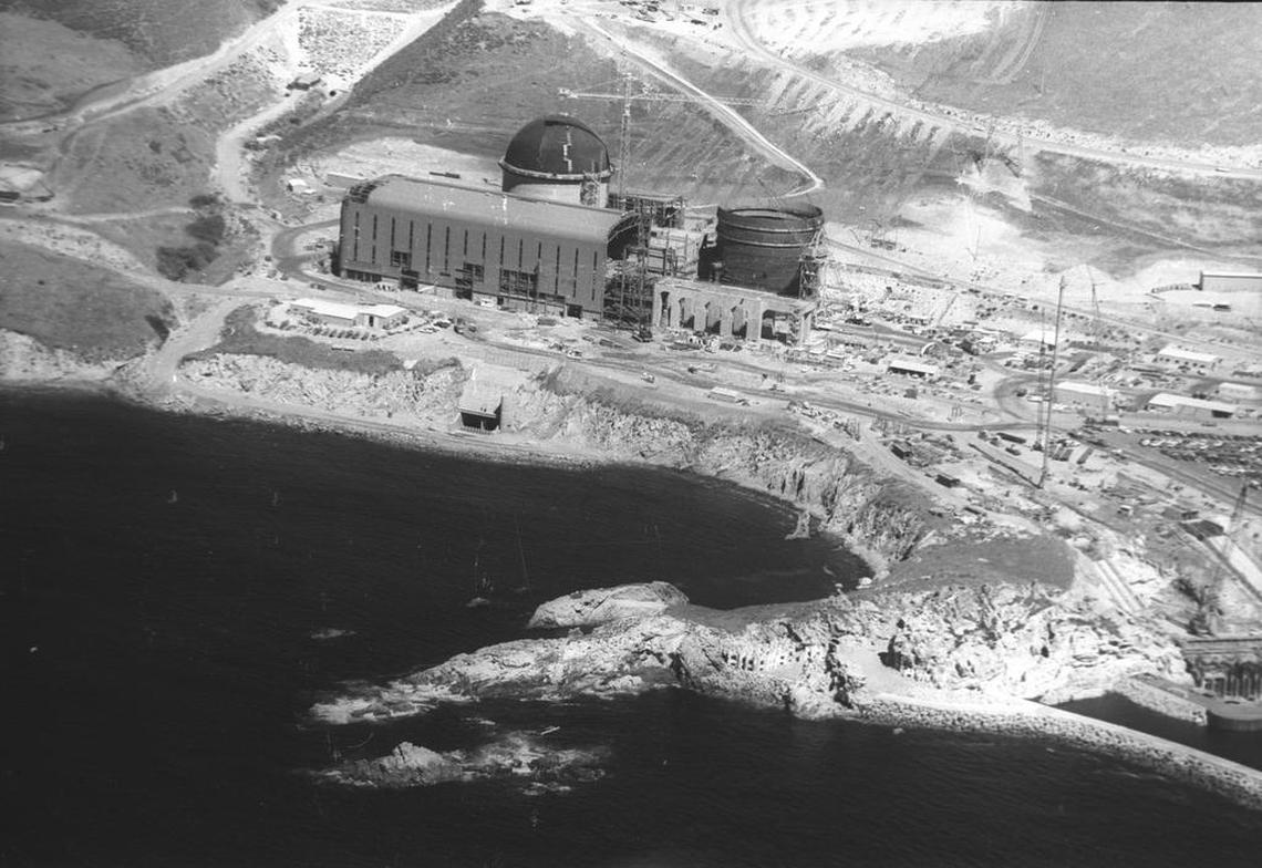 A 1972 photo shows construction proceeding at Diablo Canyon nuclear power plant. The discharge outlet for the once-through cooling system can be seen in the middle of the cove below the turbine building.