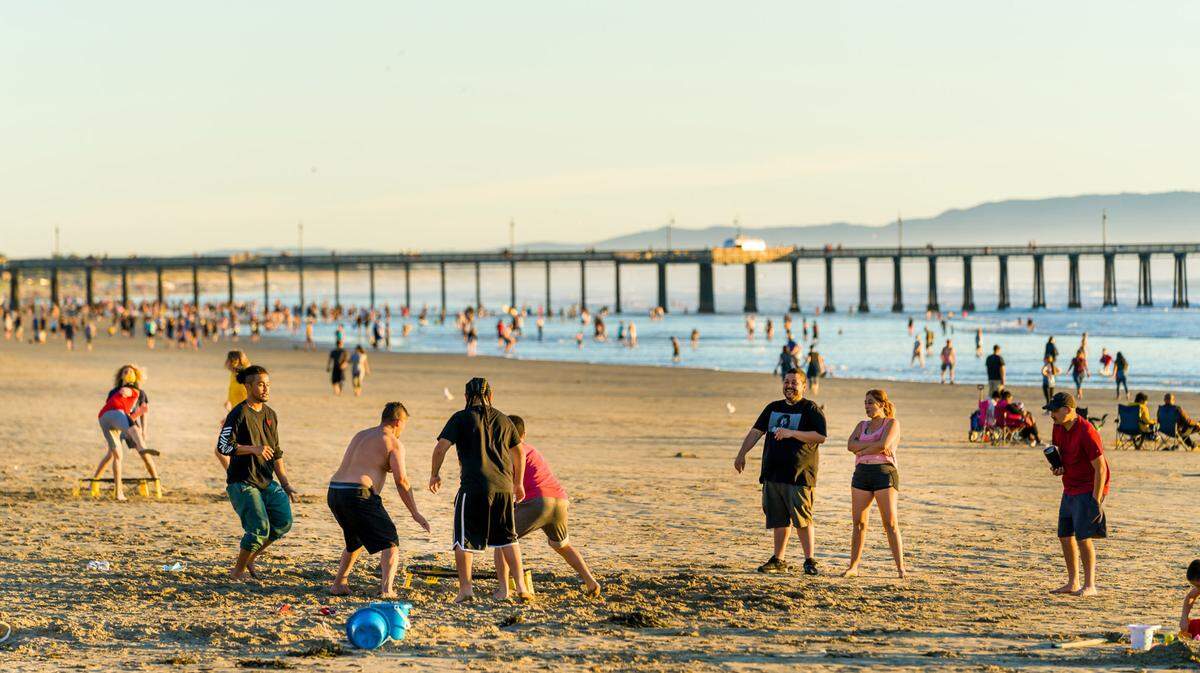 People enjoy a warm day in Pismo Beach.