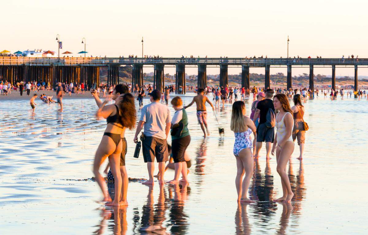 People enjoy a warm day in Pismo Beach.