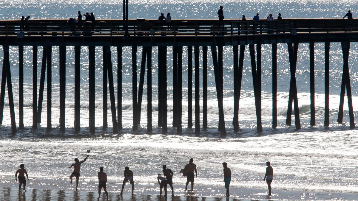 People flocked to Pismo Beach to took advantage of the sunny weather on Jan. 27, 2019. This group played rugby in the surf.