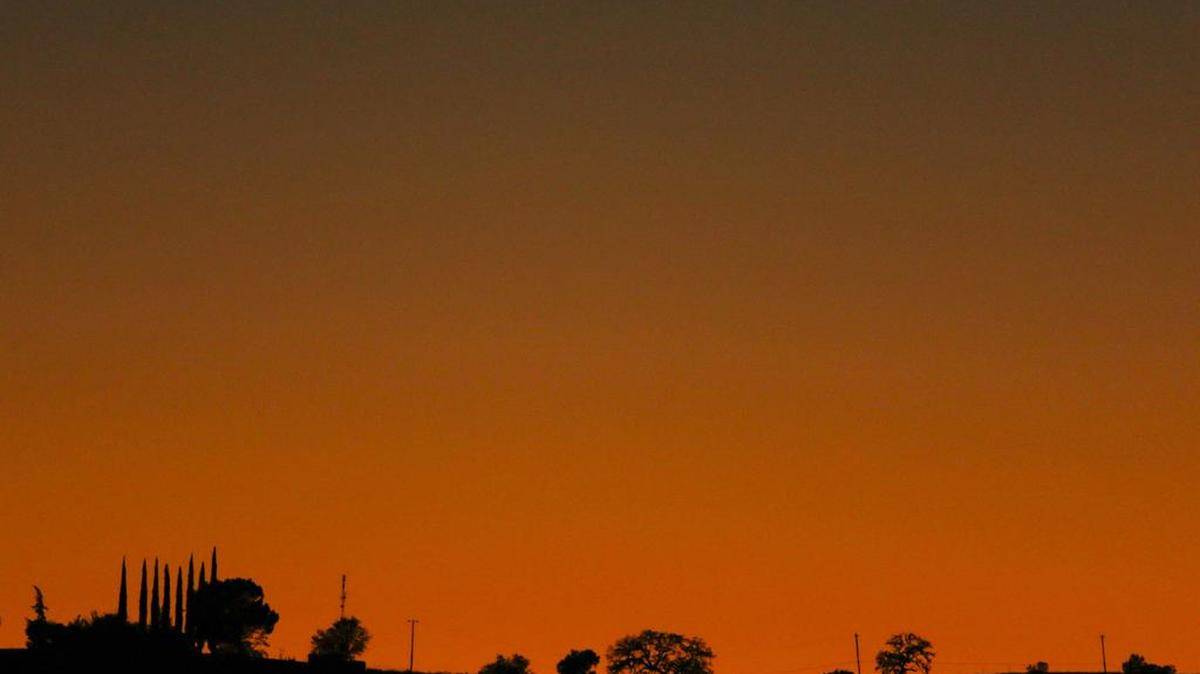 Trees are outlined in the afterglow of Monday’s sunset near Creston Road in Paso Robles.