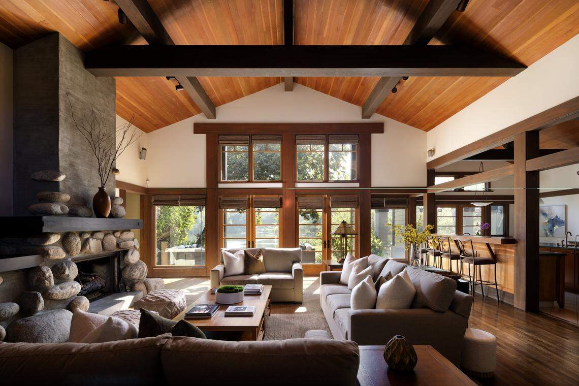 The great room features 18-foot beams with a “massive boulder fireplace” and windows overlooking the lake, the listing said.