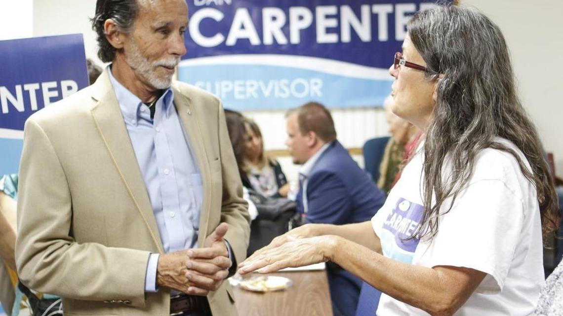 Dan Carpenter talks to supporter Patty Welsh on election night in San Luis Obispo. A second-place finish in the 3rd District supervisor race would send Carpenter into a runoff with Adam Hill in November.