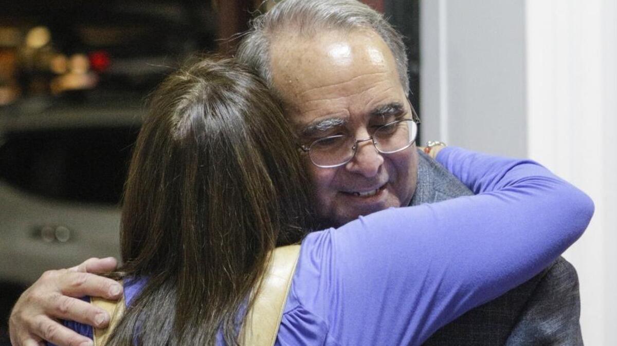 Atascadero Mayor Tom O’Malley gets a hug from a well-wisher as he visits election night parties in Paso Robles.