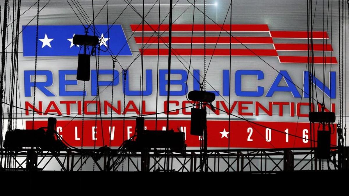 A Republican National Convention logo is seen though silhouetted production equipment on a huge video screen at Quicken Loans Arena for the Republican National Convention, Sunday, July 17, 2016, in Cleveland.