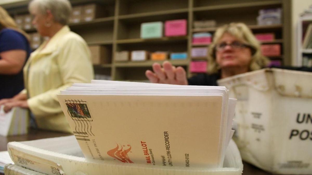 A San Luis Obispo County election worker reaches for a mailed-in ballot while reviewing envelopes for signatures and other information June 5. With a significant deadline finally past, the candidate list is almost set for most November city council and mayoral races across San Luis Obispo County.