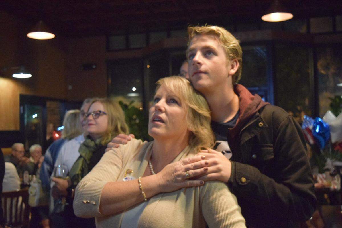 Arroyo Grande City Council member Caren Ray gets a hug from her son, Caleb, as they watch election results Tuesday night at Rooster Creek Tavern in the Village of Arroyo Grande. Ray is running for Arroyo Grande mayor against incumbent Mayor Jim Hill.