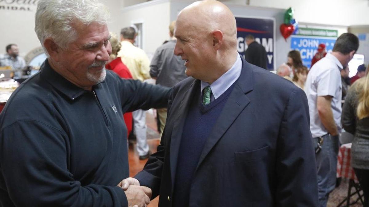 Randall Jordan, left, shakes hands with John Peschong at Peschong’s election night party in Paso Robles.