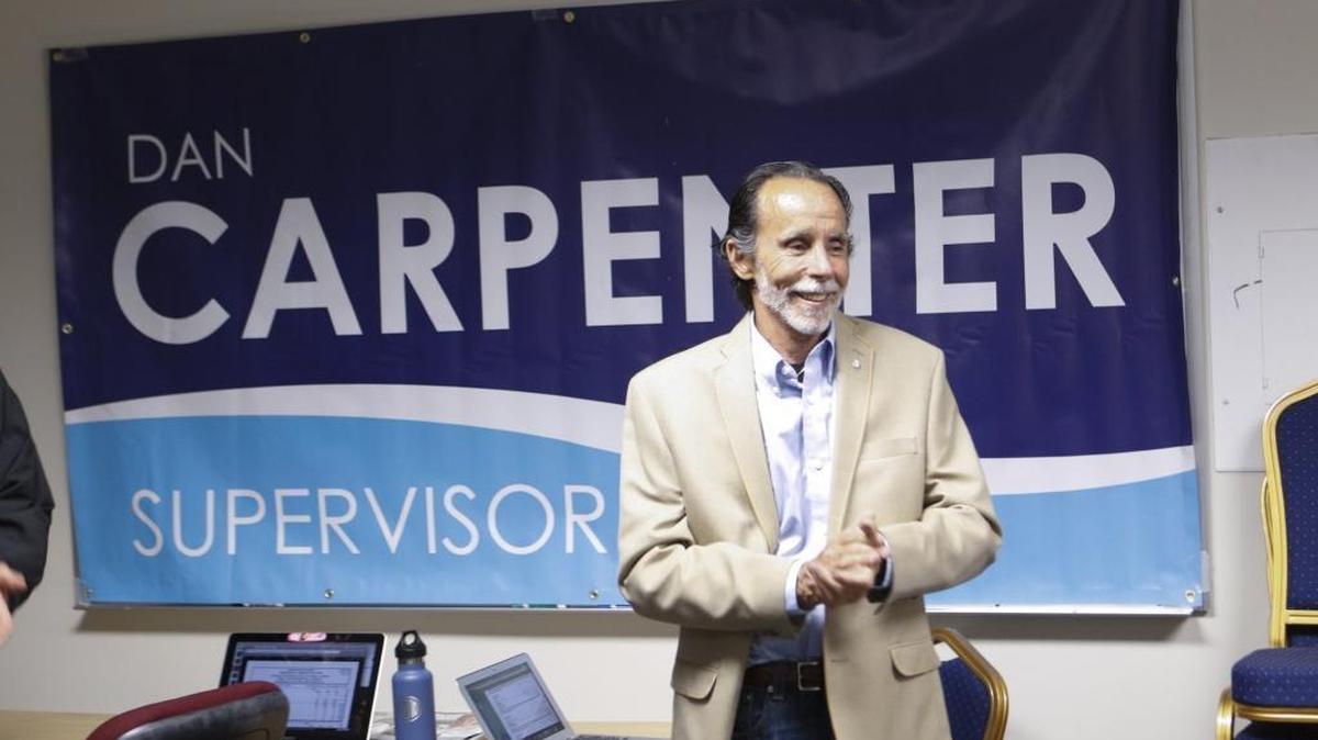 Dan Carpenter claps as election return numbers are read Tuesday night.