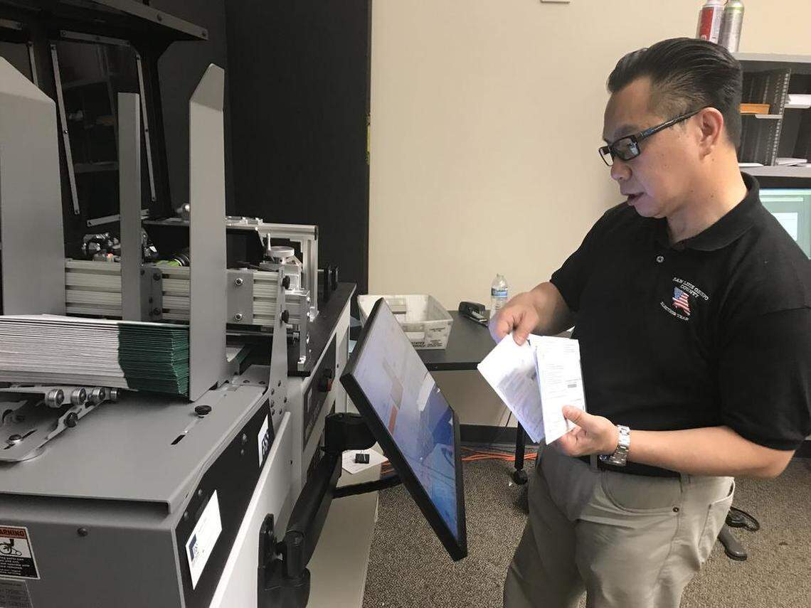 On Wednesday, San Luis Obispo County Clerk-Recorder Tommy Gong processes vote-by-mail envelopes through a machine that photographs the signature.
