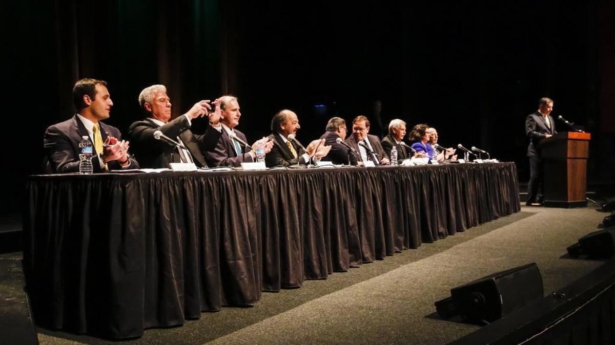 Cal Poly president Jeffrey Armstrong, right, introduces the 24th District congressional candidates (from left) Justin Fareed, William Ostrander, John Uebersax, Katcho Achadjian, Salud Carbajal, Steve Isakson, Matt Kokkonen, Helene Schneider and Jeff Oshins at the start of the debate at Cal Poly Thursday.